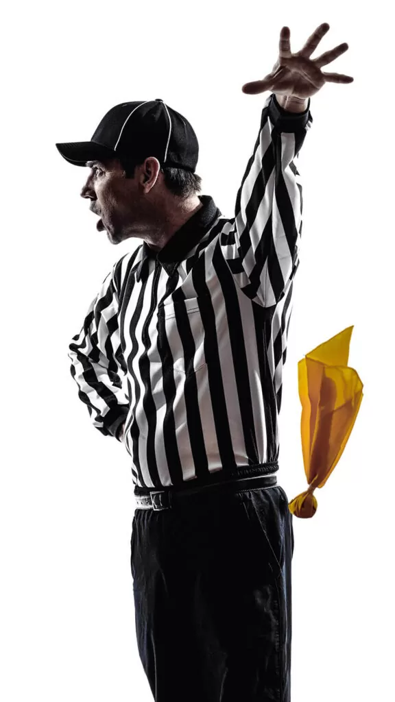 Referee throwing yellow penalty flag