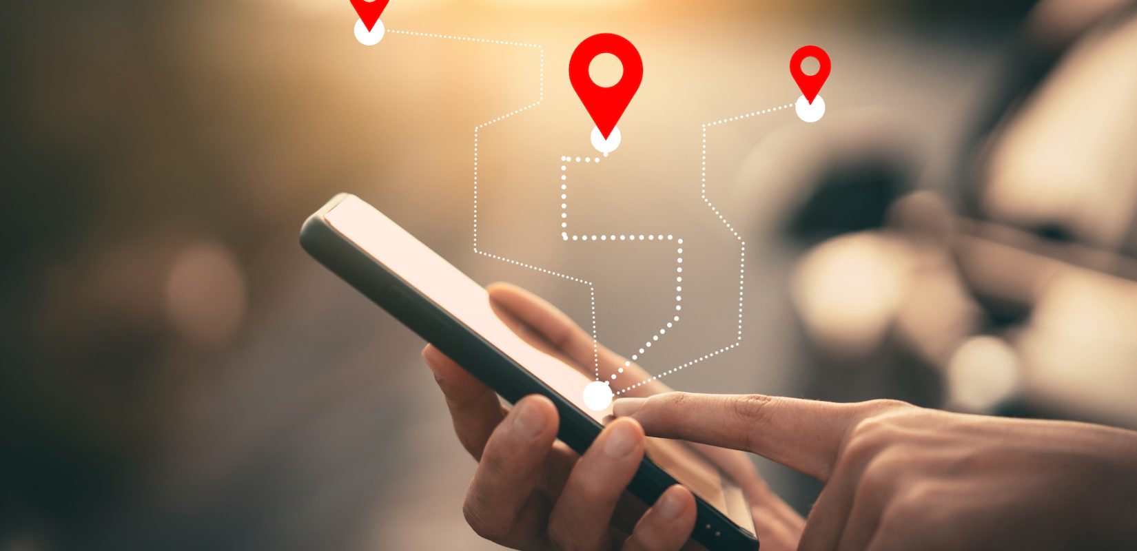 Man hand using smartphone with gps navigator map icon on blur street background. Technology lifestyle and business travel concept. Vintage filter effect color style.